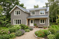 AI-generated cottage exterior inspiration with warm grey cladding and off-white trim