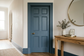 AI-generated hallway with blue matt door and trim for decorating inspiration, not a verified product application