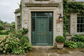 AI-generated exterior inspiration with a deep green front door and matching trim