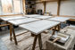AI-generated preparation scene with white primed cabinet doors on trestles